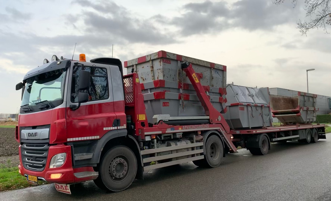 Portaalcontainers vol met afval op vrachtwagen